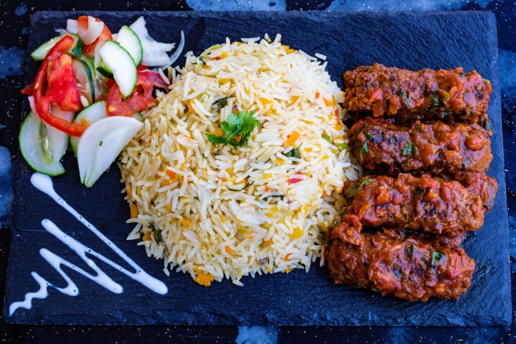 Fried Rice and Kebab with Mixed Vegetables on Blue Plate